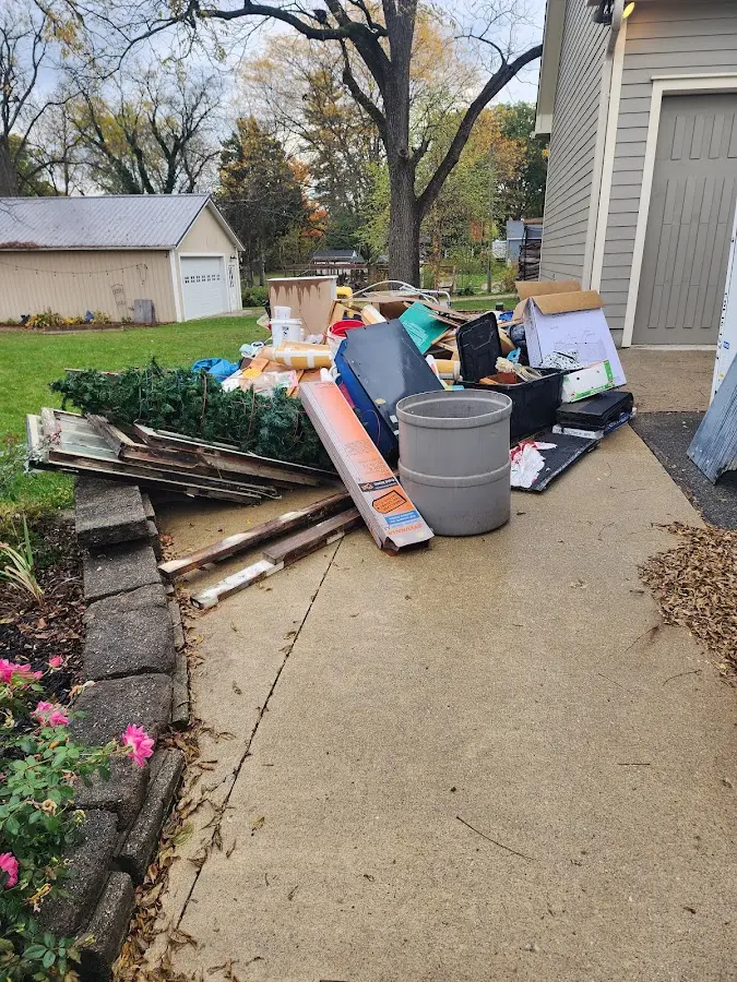 Dumpster being loaded with debris for Roofing Dumpster Rental in Milford
